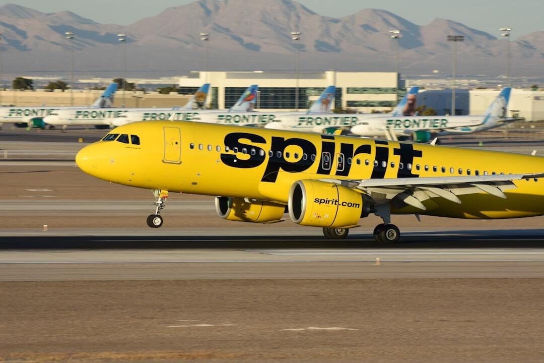 Spirit Airlines A320neo landing in Las Vegas with Frontier Airlines jets in the background
