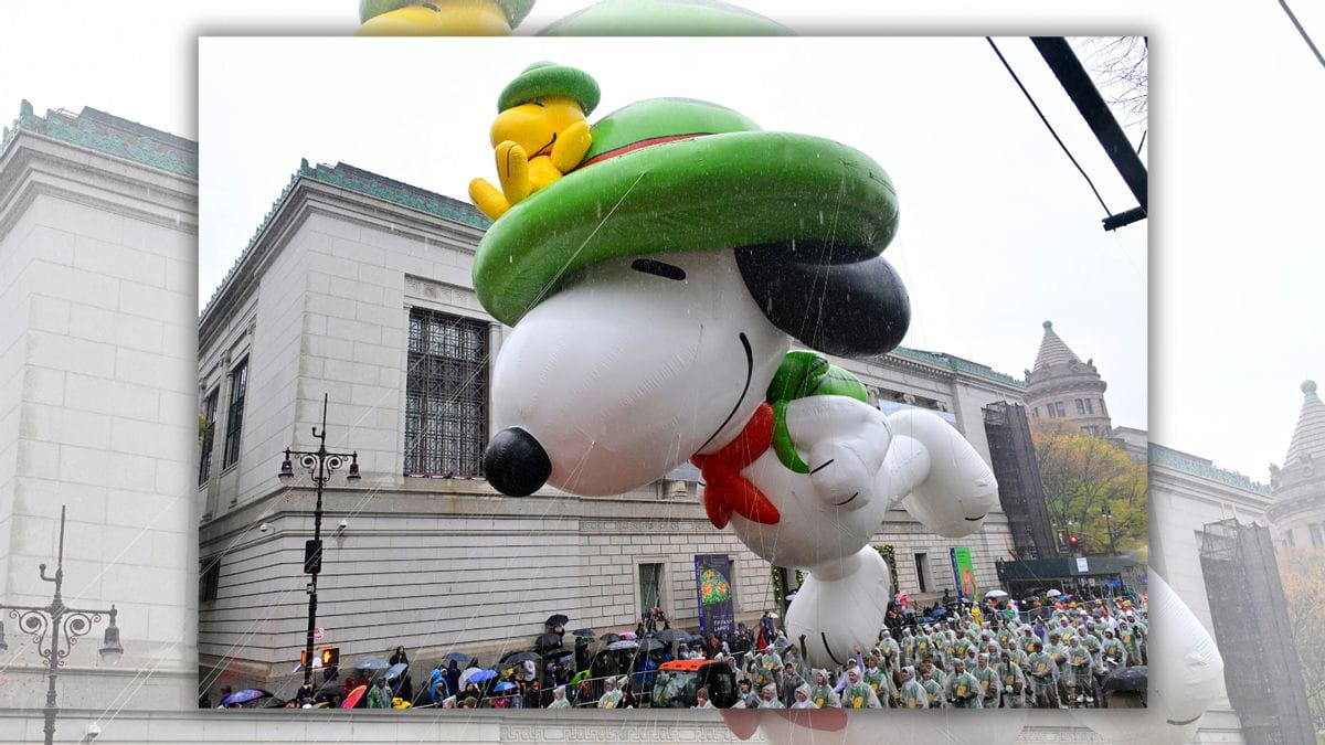 A large Snoopy float is shown. Many people can be seen beneath it.