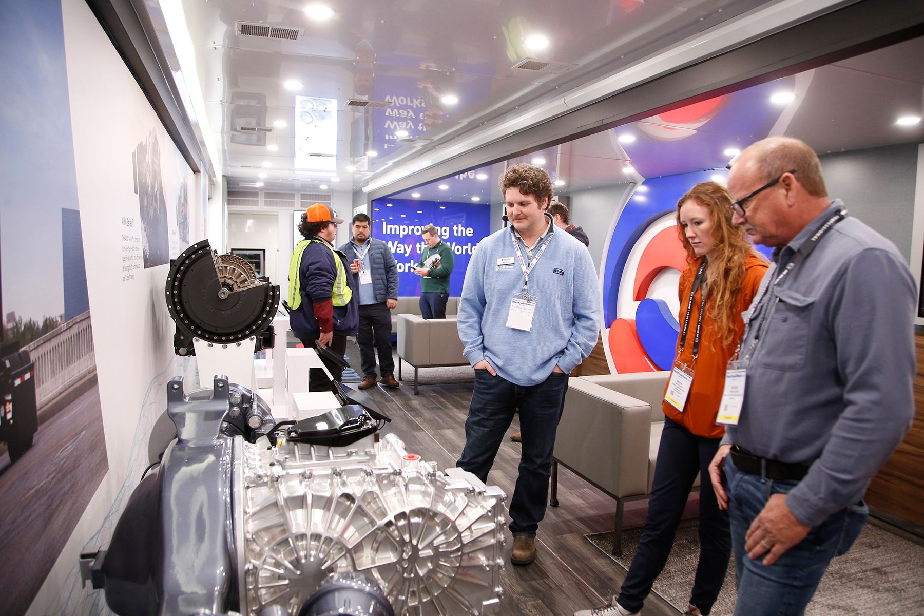 Fleet buyers examining a powertrain during a ride and drive experience at NTEA Work Truck Week