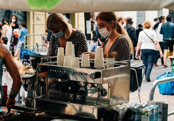 people wear facemasks while waiting for their coffee