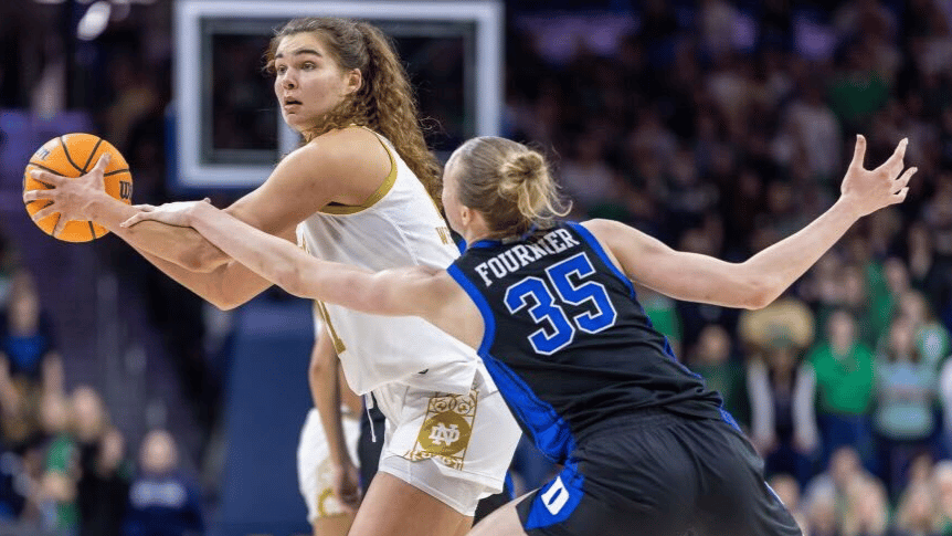 Maddy Westbeld of Notre Dame holds the ball against Toby Fournier of Duke