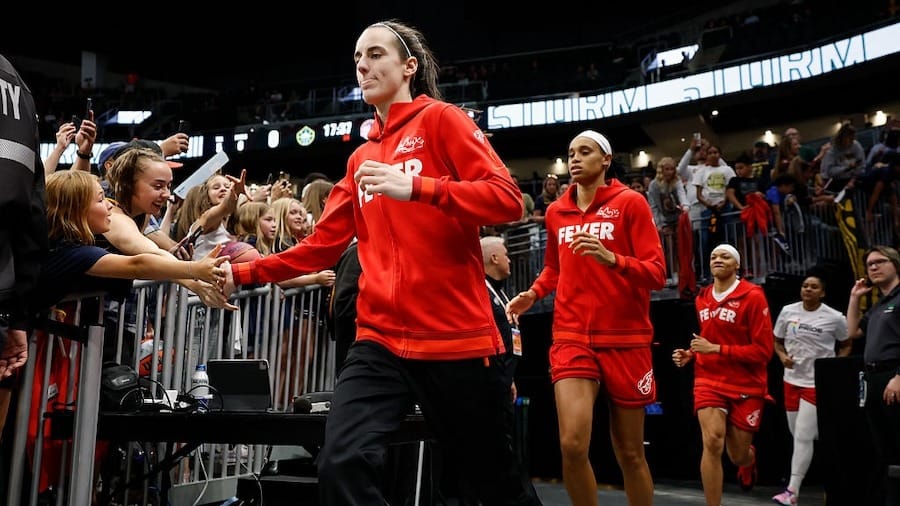 Caitlin Clark #22 of the Indiana Fever runs out of the team tunnel, to the court before the game against the Seattle Storm at Climate Pledge Arena on June 24, 2025 