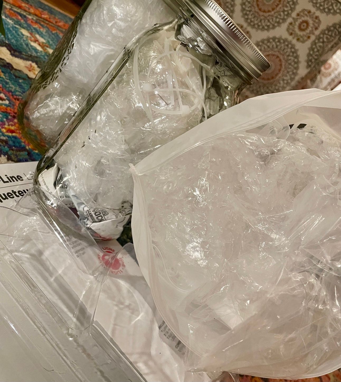 Company plastic waste - bags, tape, labels, packaging, zip-ties are consolidated into two 1/2 gallon jars and 1 small bag.