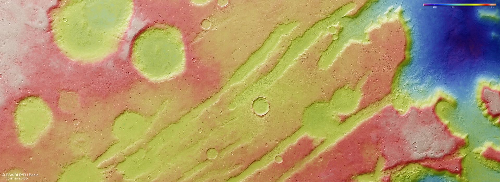 In this image, based on a digital terrain model of the region, from which the topography of the landscape can be derived, lower parts of the surface are shown in blues and purples, while higher altitude regions show up in whites and reds, as indicated on the scale to the top right.