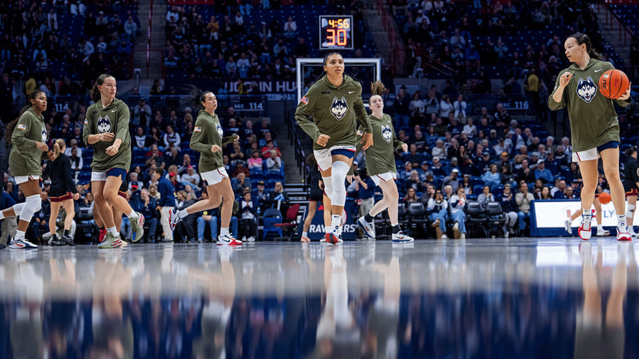 Ashlynn Shade #12, Azzi Fudd #35 and Kayleigh Heckel #9 of the Connecticut Huskies warm up before an NCAA women's basketball game against the Loyola Ramblers on November 12, 2025 in Storrs, Connecticut.