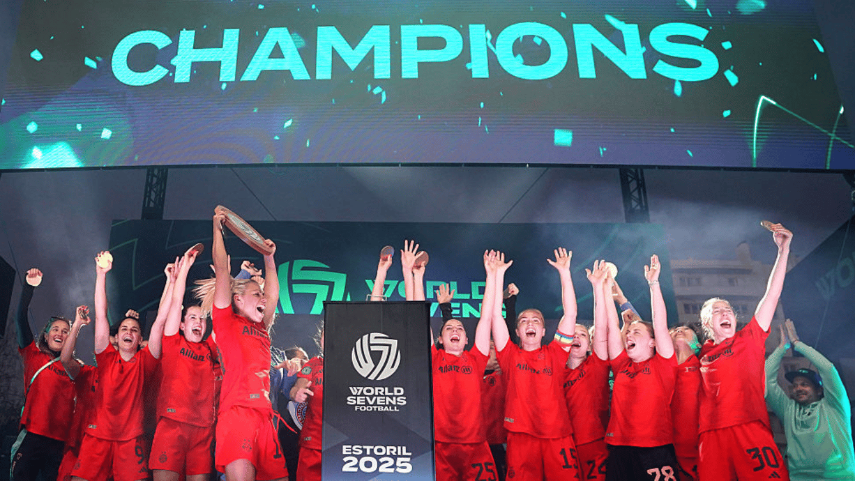 Linda Dallmann of Bayern Munich lifts the World Sevens Football trophy after the team's victory in the World Sevens Football Final match between Bayern Munich and Manchester United on Day Three at Estadio Antonio Coimbra da Mota on May 23, 2025 in Estoril, Portugal. (