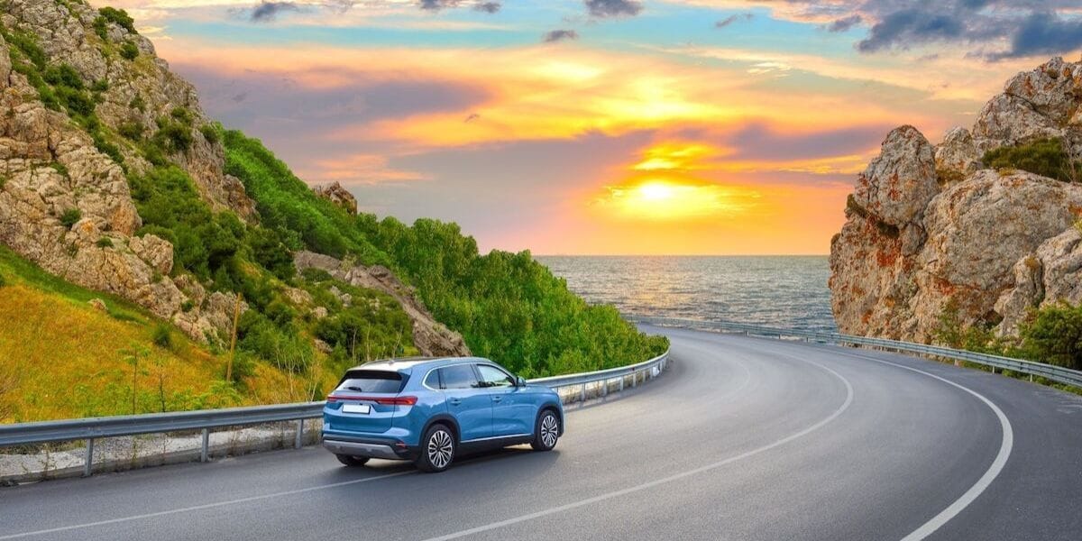 a car driving among the sunset