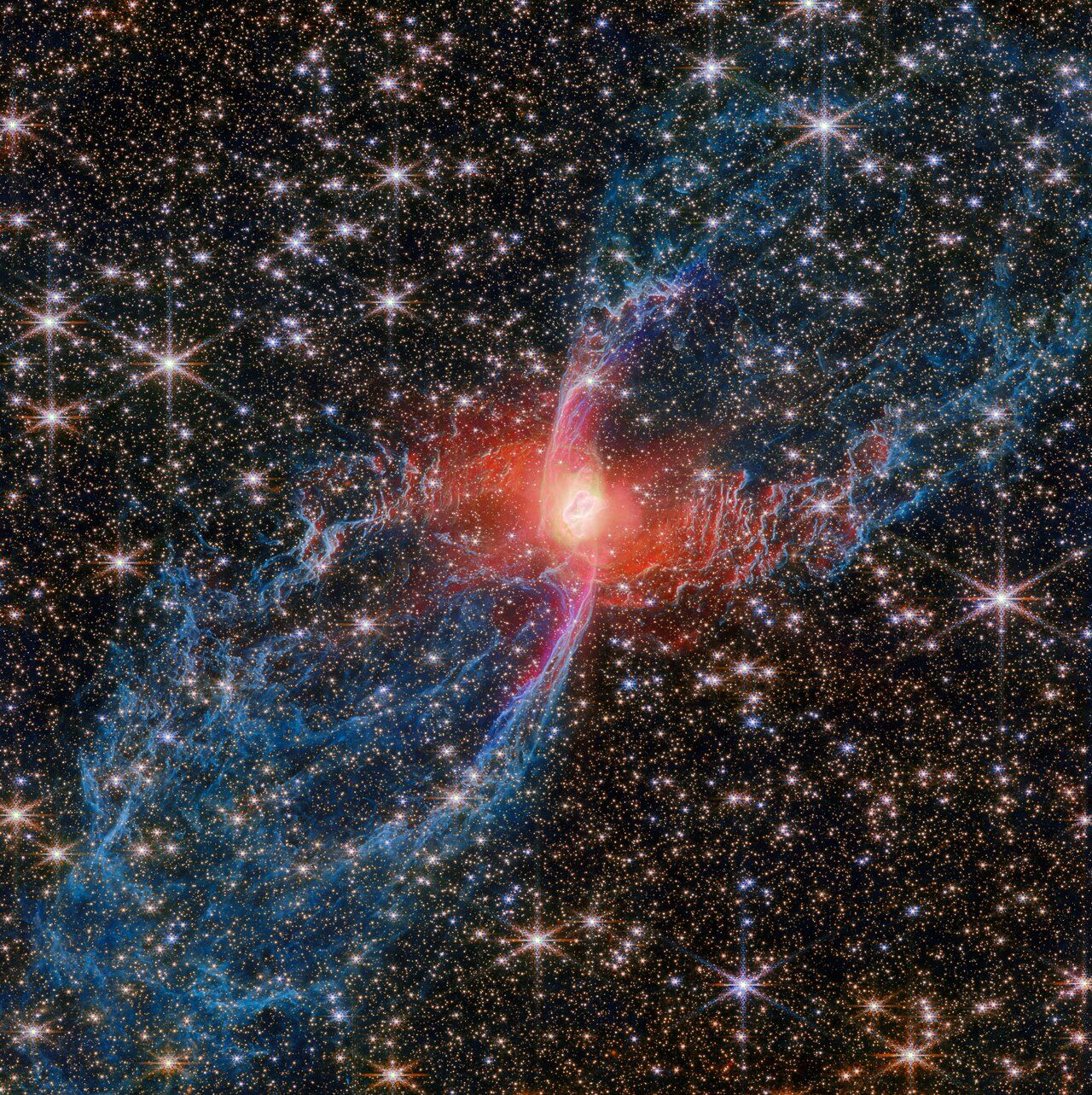 The James Webb Space Telescope has captured unprecedented details of NGC 6537, known as the Red Spider Nebula, revealing new insights into planetary nebula formation and stellar evolution. Using its Near-Infrared Camera (NIRCam), Webb imaged the nebula’s central star—previously faint in optical wavelengths—as a red source surrounded by hot dust, possibly in a disc. The image shows massive, closed lobes extending 3 light-years, traced by molecular hydrogen, and a fast-moving jet marked by ionized iron forming an elongated S-shape. These features suggest dynamic outflows and hint at a hidden companion star shaping the nebula’s hourglass structure. 