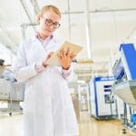 Portrait Shot Of Pretty Blonde Technologist Wearing White Coat T