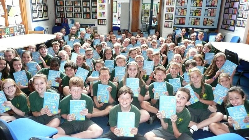 a class at whiteley primary school holding books they have been gifted by the rotary 