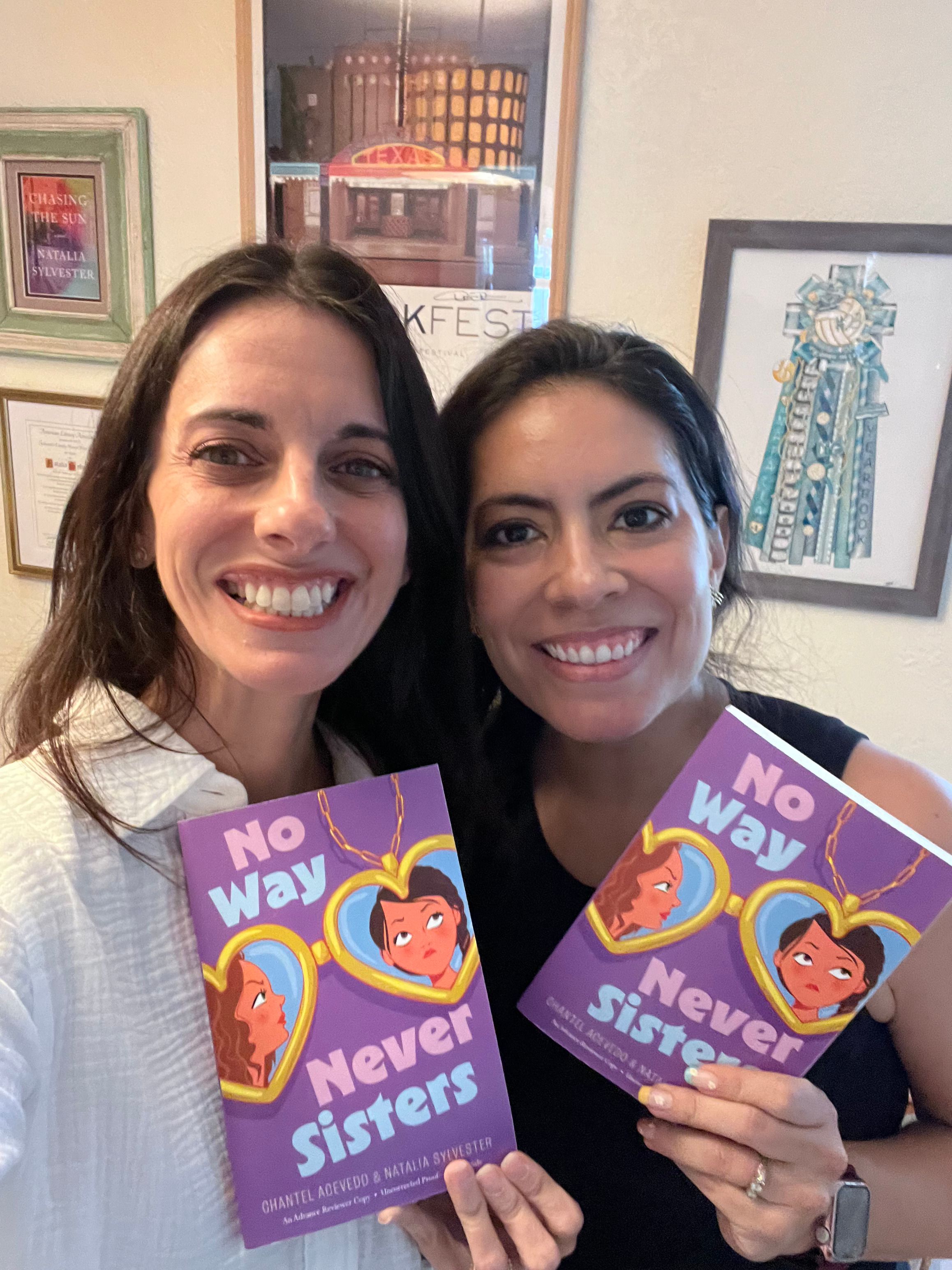 A selfie of Chantel and Natalia holding advance reader copies of their book. 