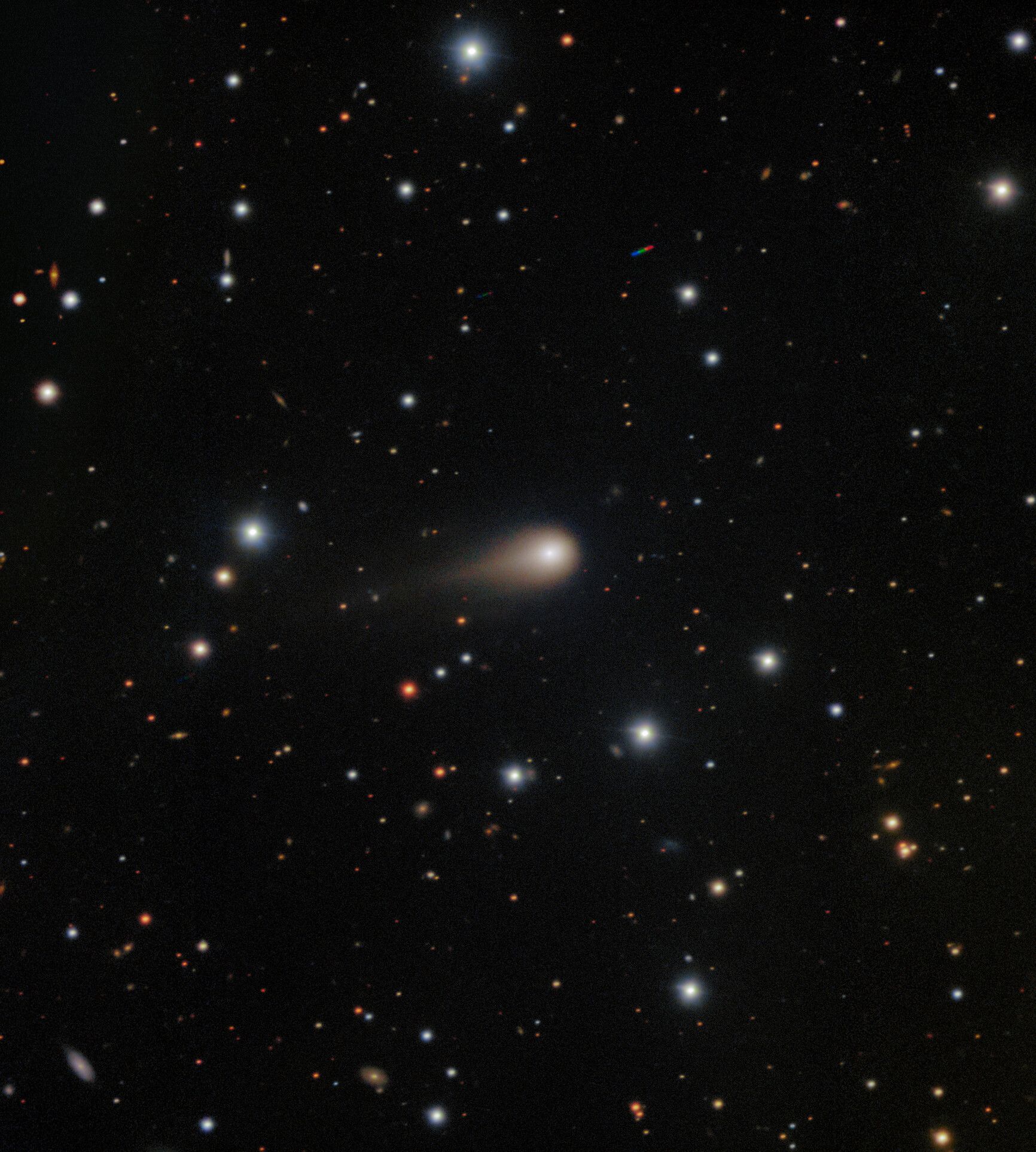 Interstellar comet 3I/ATLAS, captured by Gemini South’s GMOS instrument, displays a broad coma and a growing tail as it nears the Sun. The deep image, taken during NOIRLab’s “Shadow the Scientists” program, reveals ancient material from beyond our solar system and includes faint trails from unrelated asteroids.