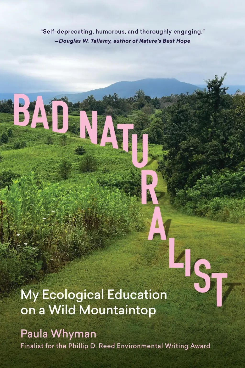 a lush green landscape of part of the meadow in summer. The mowed path is being traversed by the main title "bad naturalist" in pink, as the letters seem to step along, descending the path. In the sky is Doug tallamy's comment, Self-deprecating, humorous, and thoroughly engaging. The subtitle and author name are in the bottom left, and below that in pink is a line that says the book is a finalist for the Reed Environmental Writing Award 