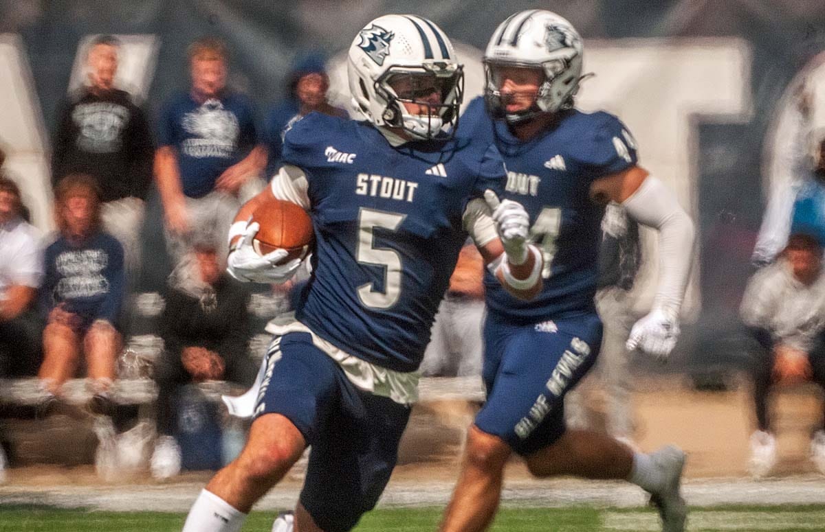 A UW-Stout football player returns an interception