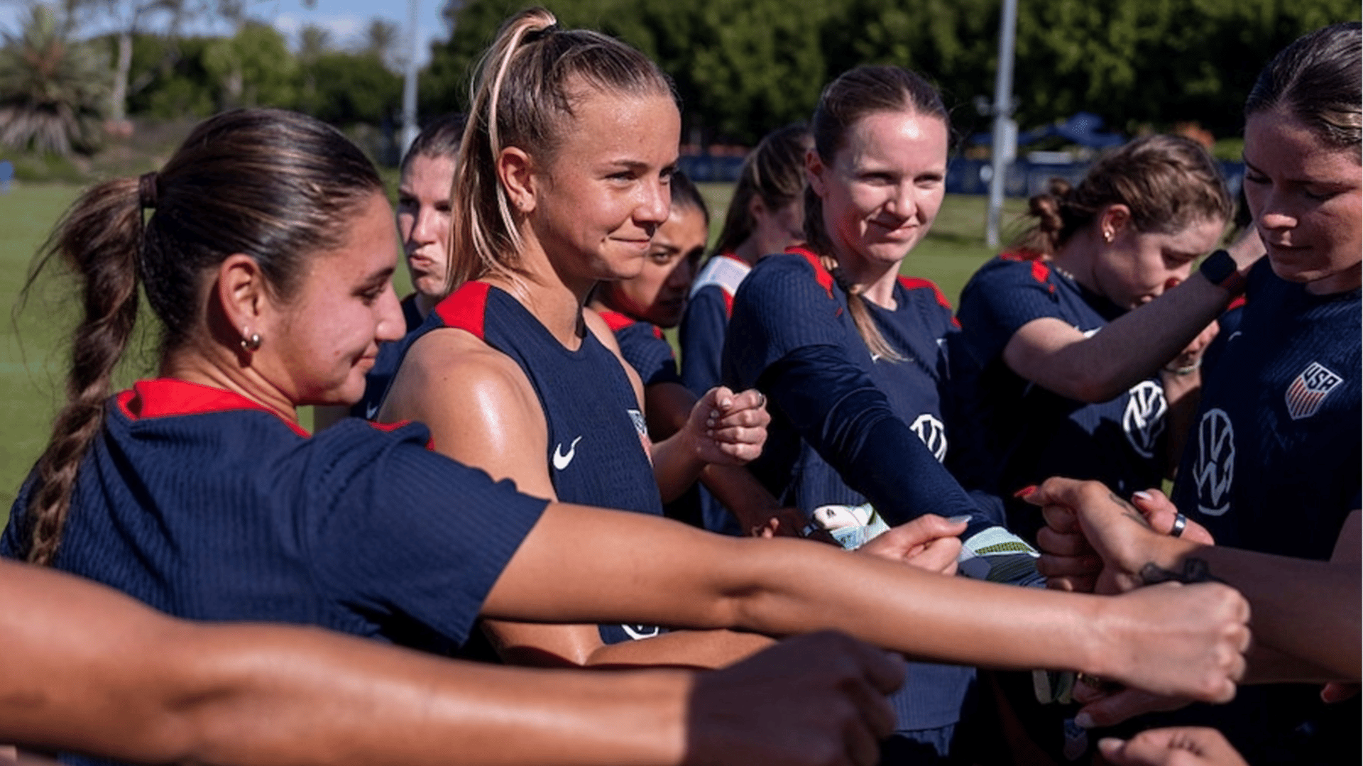 Claire Hutton of the United States huddles with the team after USWNT training