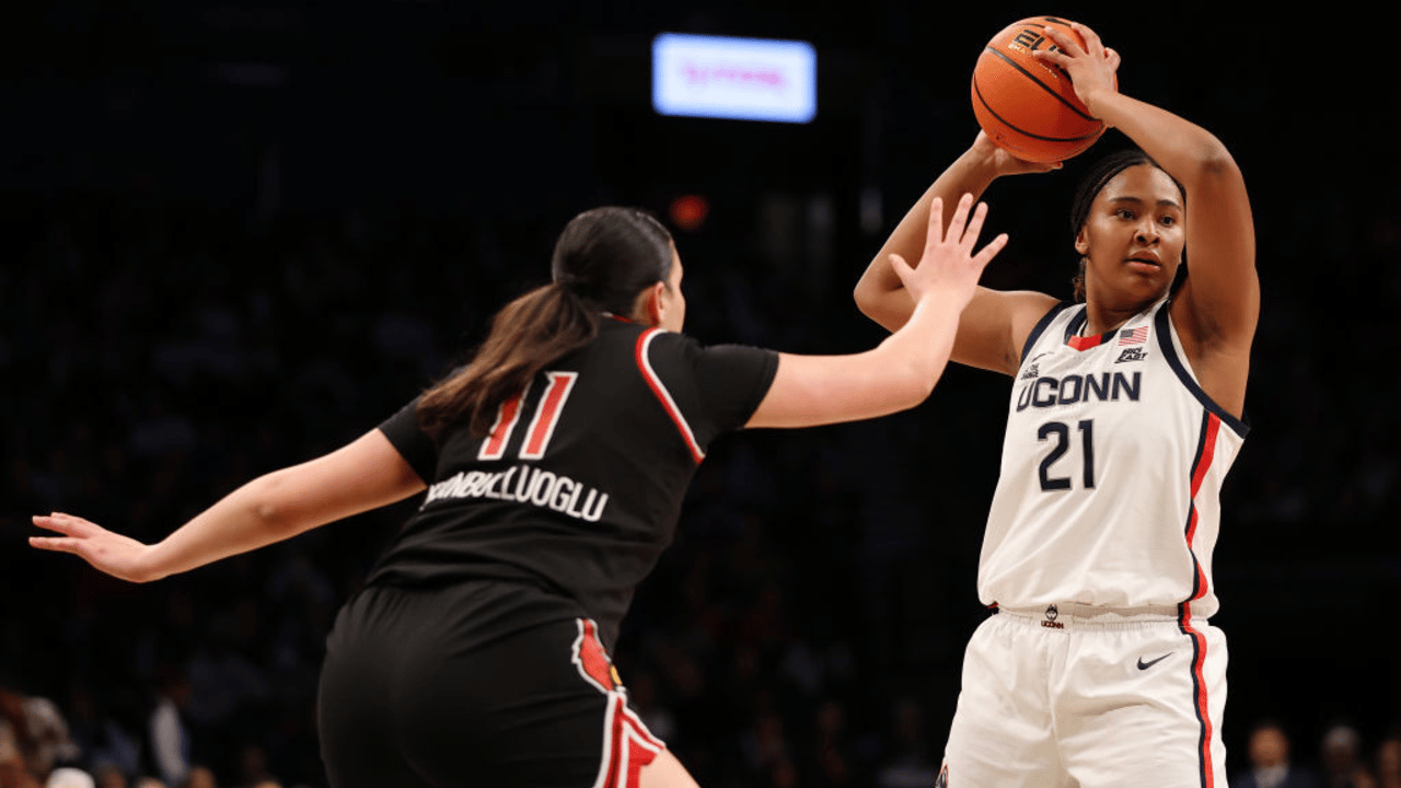 Sarah Strong #21 of the UConn Huskies looks to pass against Elif Istanbulluoglu #11 of the Louisville Cardinals during the first half in the Shark Beauty Women's Champions Classic at Barclays Center on December 07, 2024 in the Brooklyn borough of New York City.