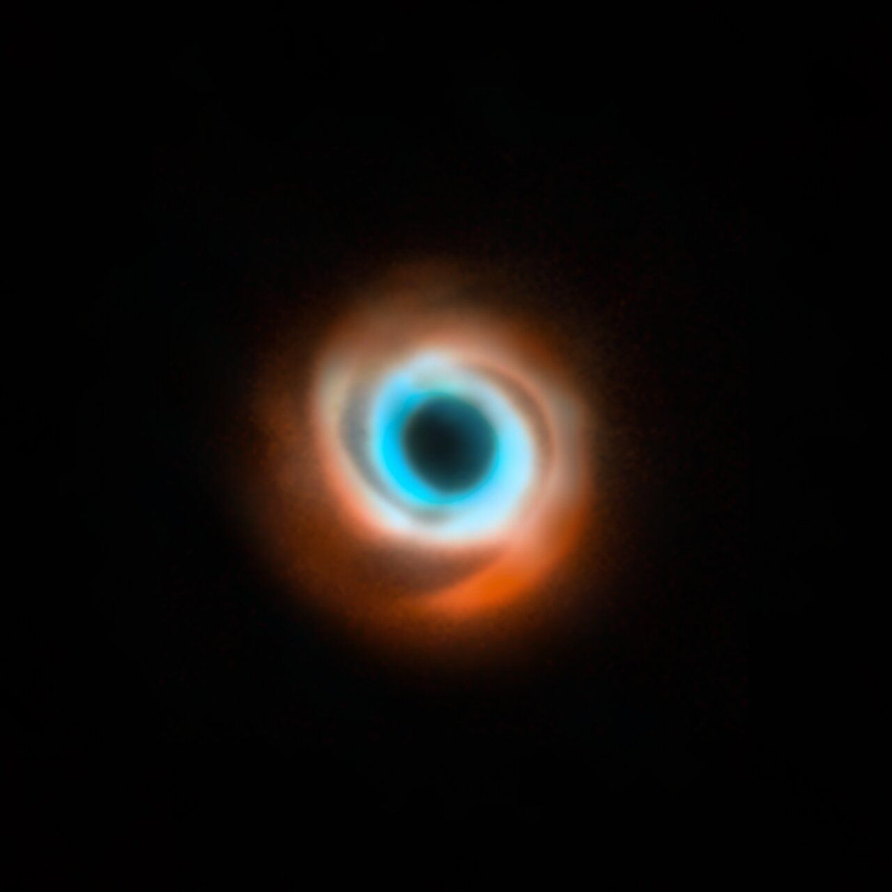 This image shows the dusty disc around the young star HD 135344B. It’s a combination of data taken with two different facilities: the Spectro-Polarimetric High-contrast Exoplanet Research (SPHERE) instrument at ESO’s VLT in red, and the Atacama Large Millimeter/submillimeter Array (ALMA) in orange and blue. The original SPHERE and ALMA images were released in 2016 and 2015 respectively and didn’t show evidence for the presence of a planet in this disc, first revealed in 2025. 