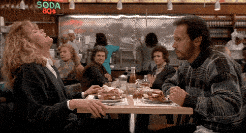 Meg Ryan banging the table in a diner with Billy Crystal nervously watching
