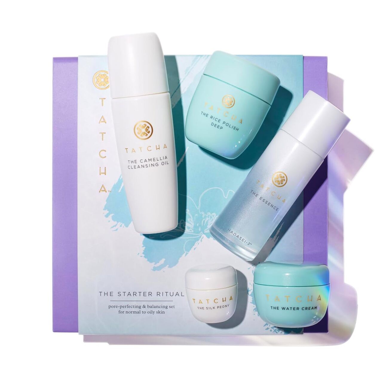 Tatcha Starter Ritual Set Elegant Tatcha skincare set featuring cleanser, essence, and moisturizer in sleek, travel-sized bottles, arranged with Japanese-inspired packaging.