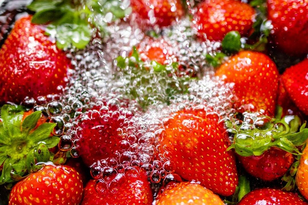 Rinsing some fresh strawberries that I brought home from the grocery store.