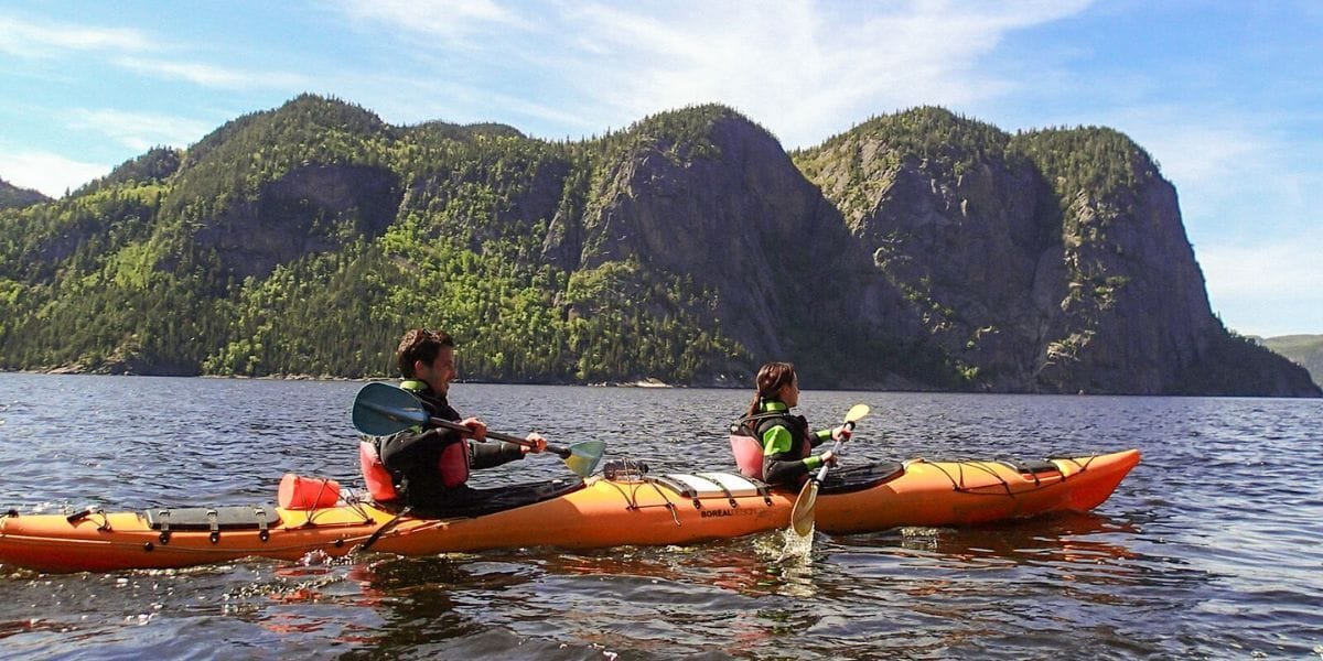 two people kayaking in an inlet