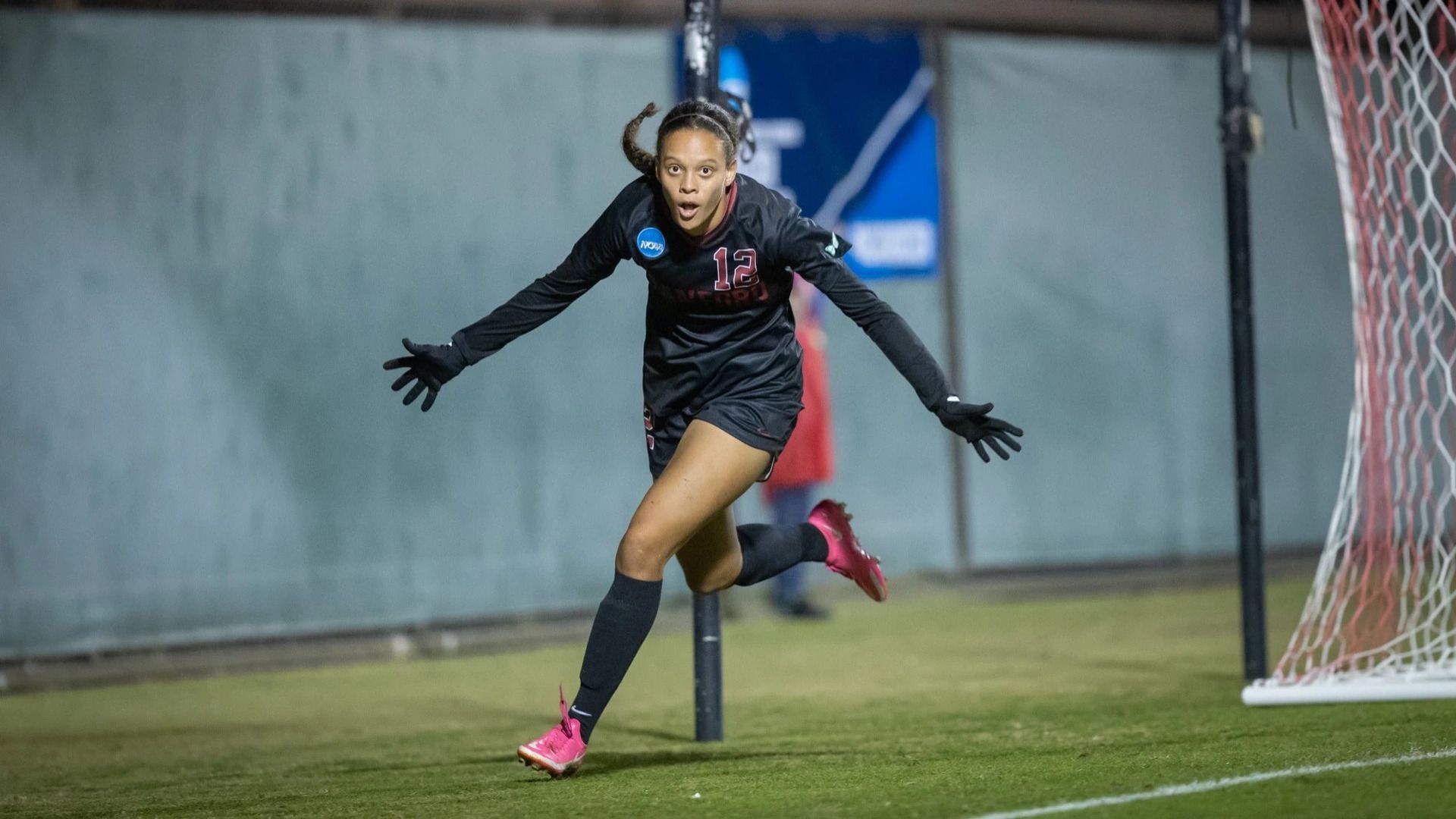 Jasmine Aikey celebrates a goal in a black Stanford jersey