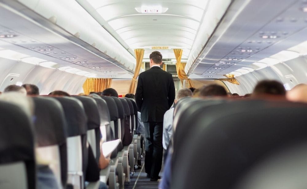 flight attendant walking down the aisle