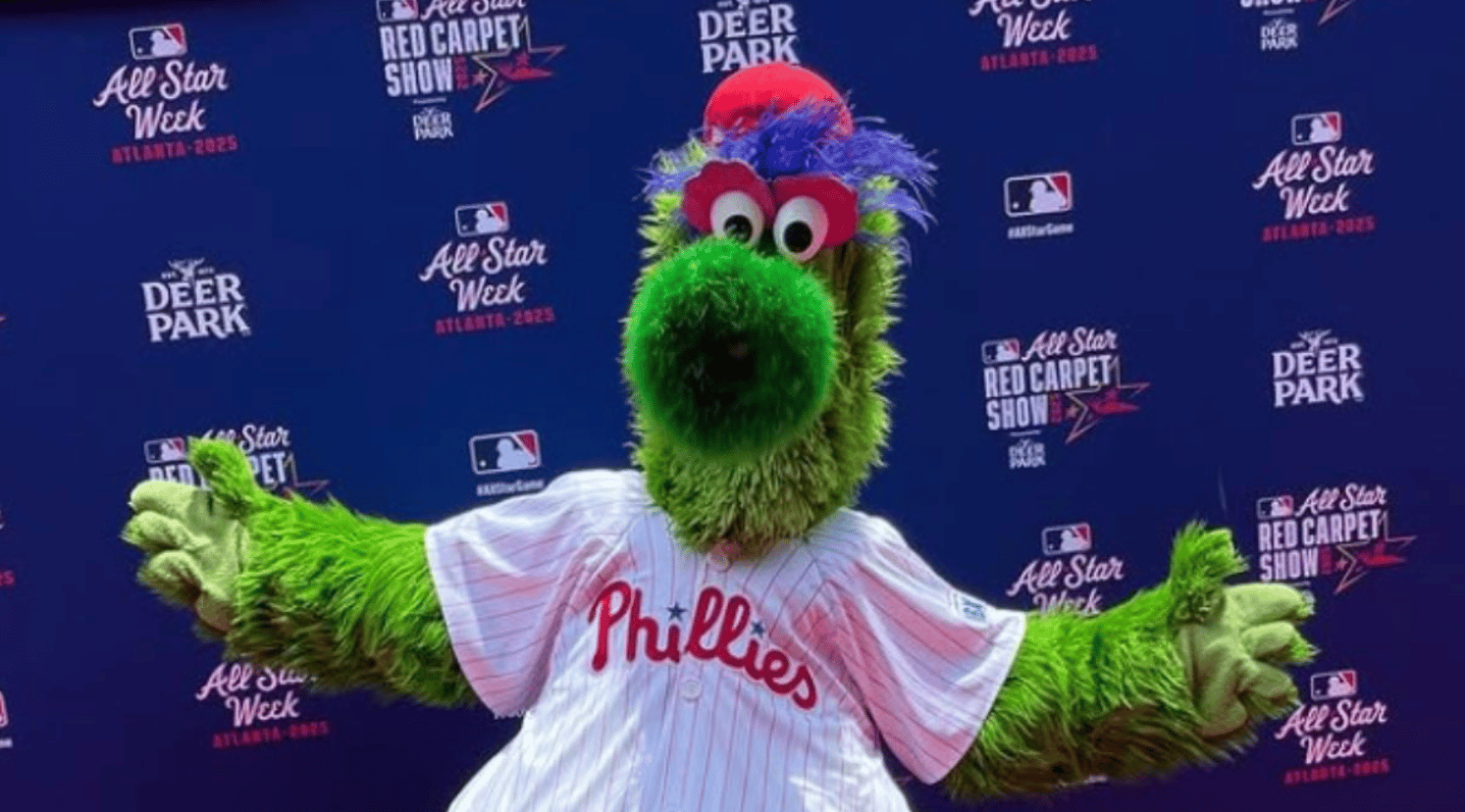 Image shows the Phillie Phanatic posing for fan pictures.