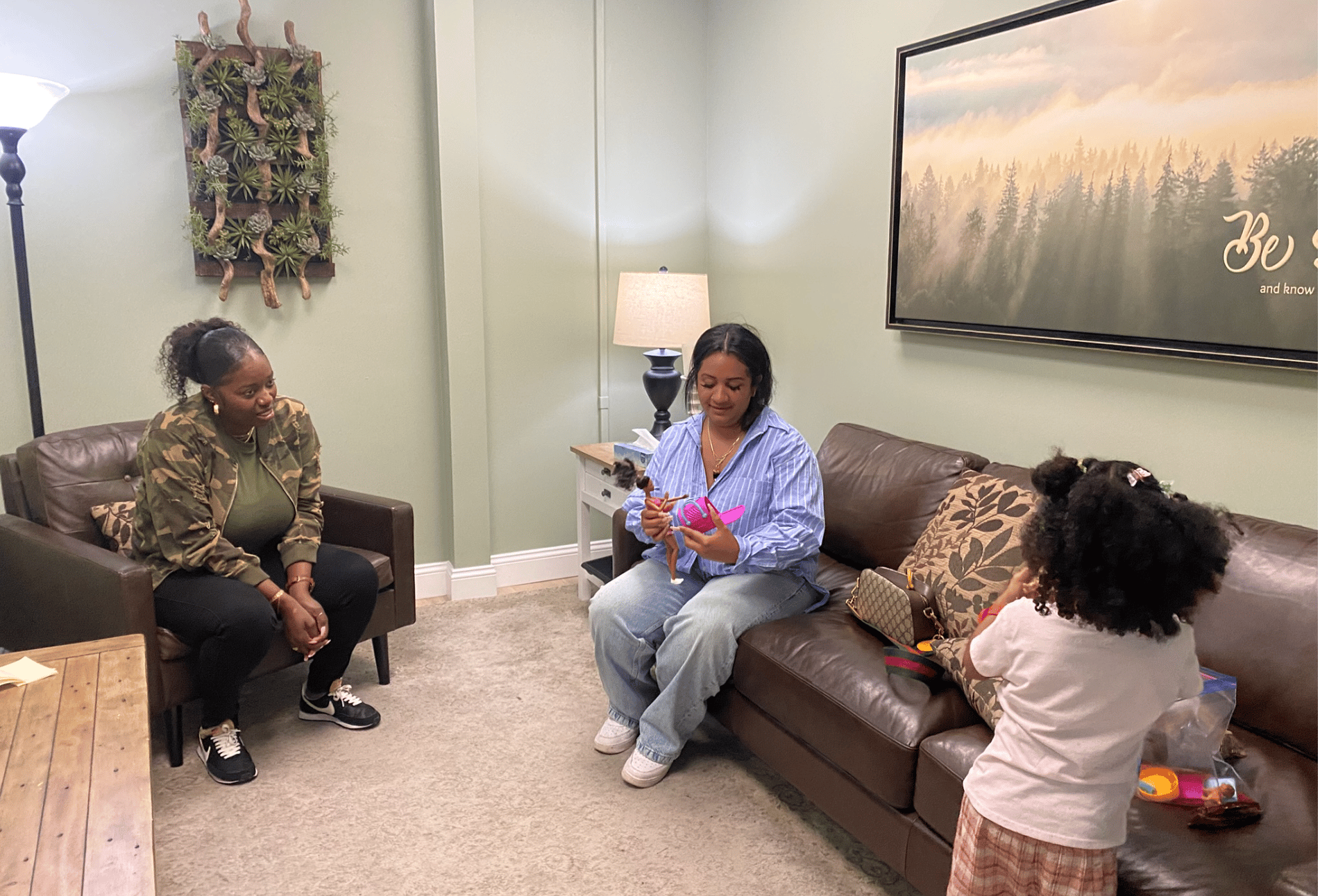 Danielle Valdes sits beside her daughter Misty and case worker Brenda Speight at the Door of Hope office.
