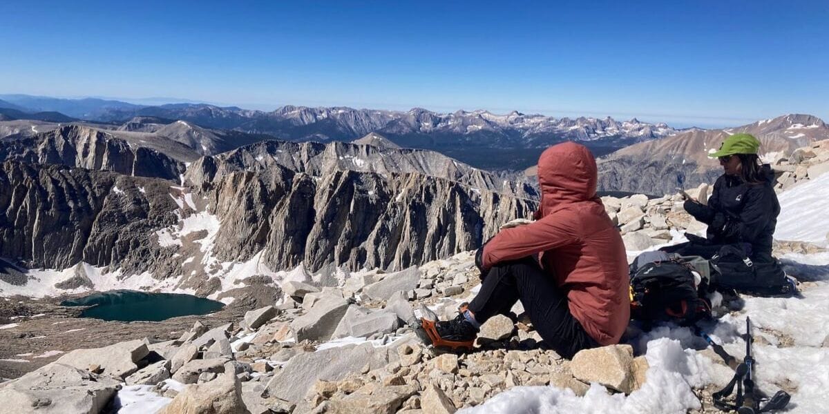 two hikers overlooking a mountain range
