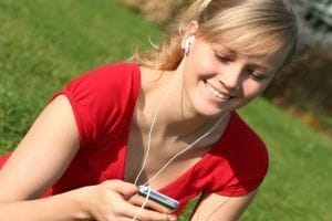 Sporty woman listening to mp3 music