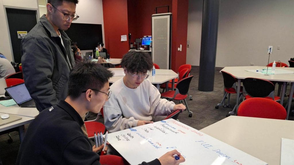 Source: University of Auckland. Hackathon participants Hao Yan (standing), Xincheng Li (left sitting) and Gavin Gao).