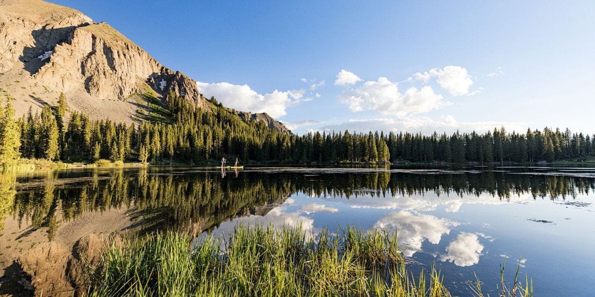 lake reflecting clouds and a mountain