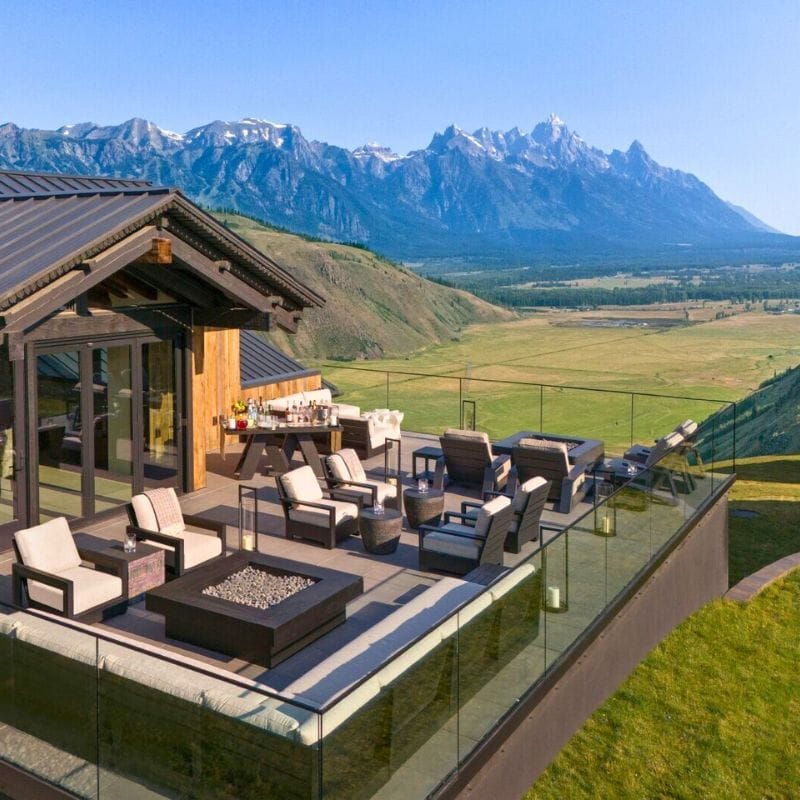 A view of a hotel with mountains in the background