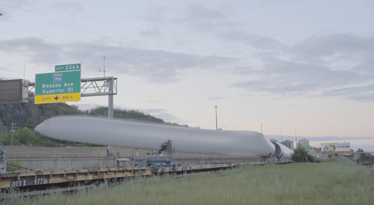 Wind turbine blades line the railroad tracks near the “Point of Rocks,” a geographic and political point of delineation between east and west Duluth. Credit: Jordan Haedtler