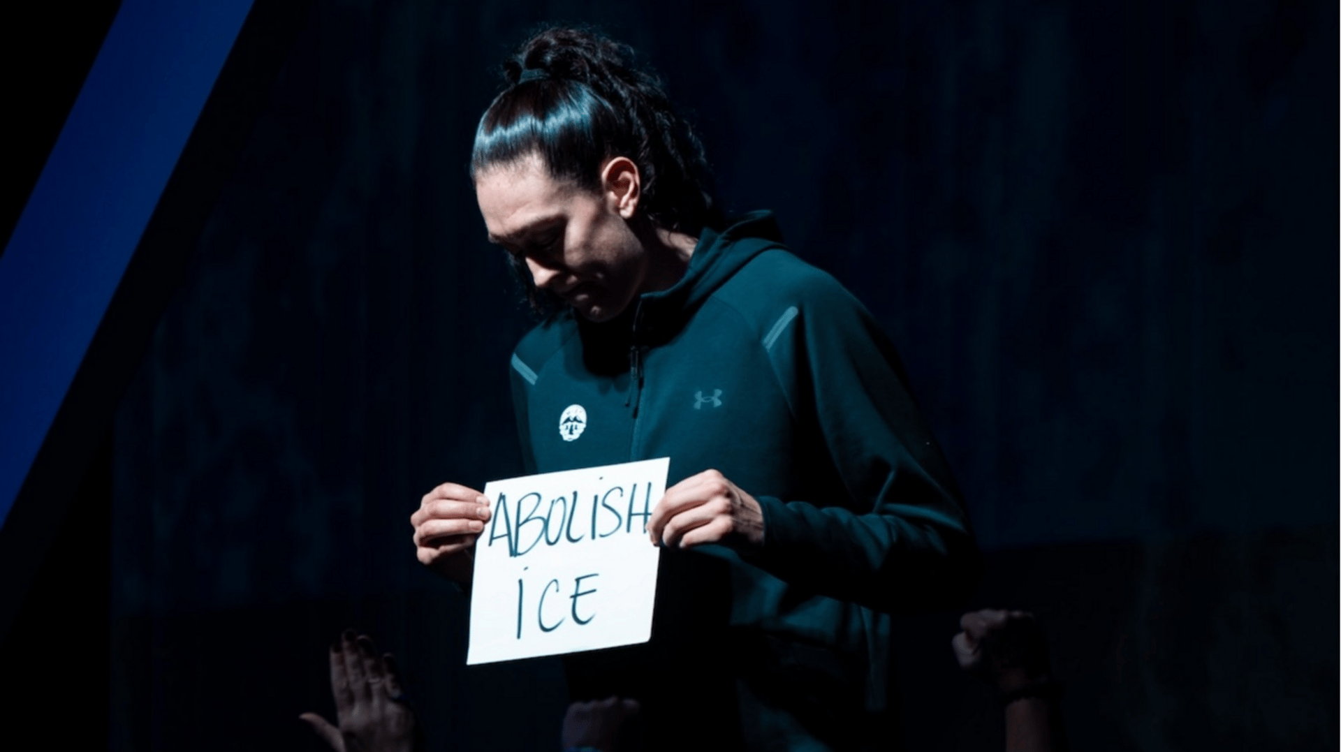 Breanna Stewart holds a signing saying "Abolish ICE" as part of her Unrivaled introduction