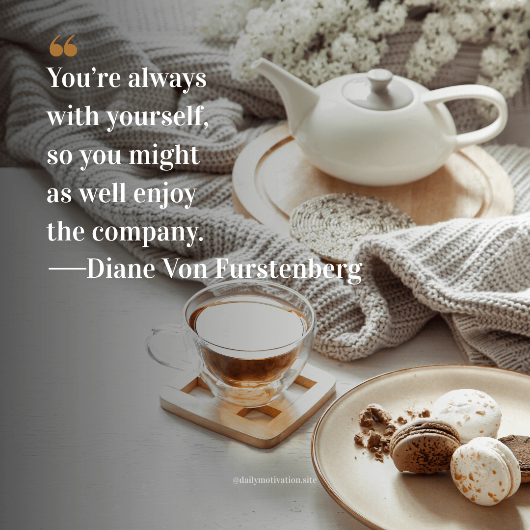 Cozy tea setting with teapot, cup of tea, and macarons on a wooden table. Quote by Diane Von Furstenberg: “You’re always with yourself, so you might as well enjoy the company.”