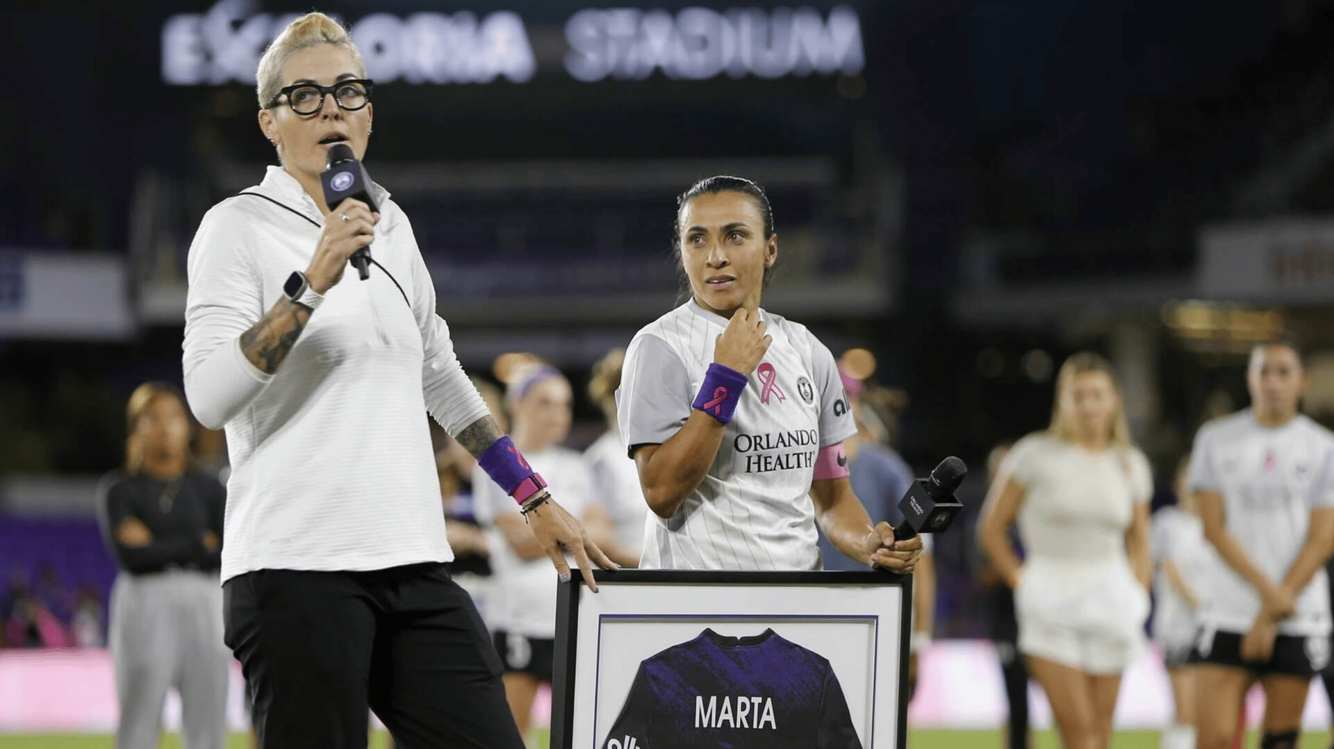 Orlando Pride forward Marta (10) with general manager Haley Carter during a ceremony to celebrate her 100 appearances at Exploria Stadium.