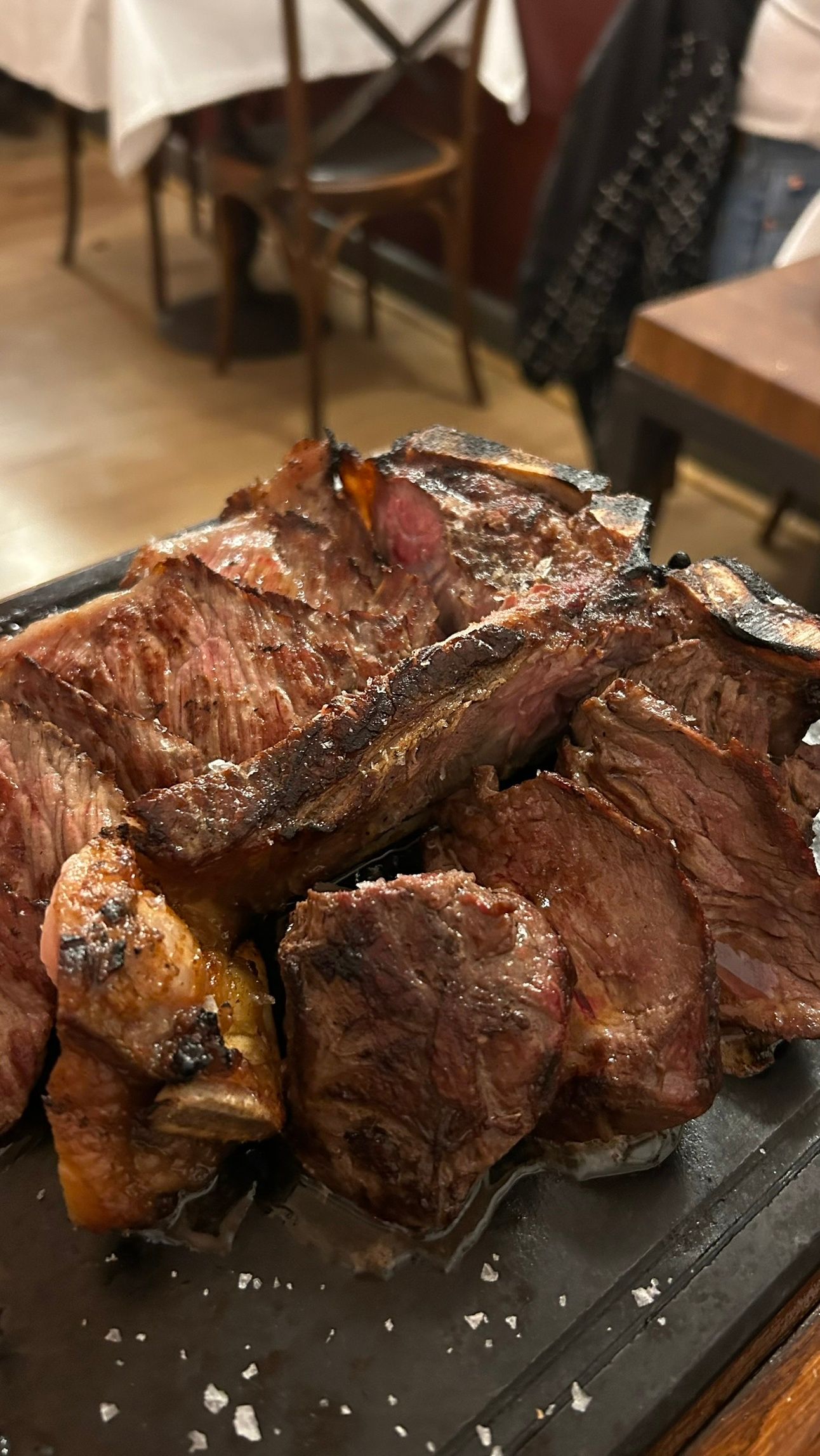 A thick, juicy Bistecca alla Fiorentina, grilled to perfection. Best enjoyed with a glass of Tuscan red wine, transported safely in Jimmy the Fox Bottle Italy Wine Travel Bag.