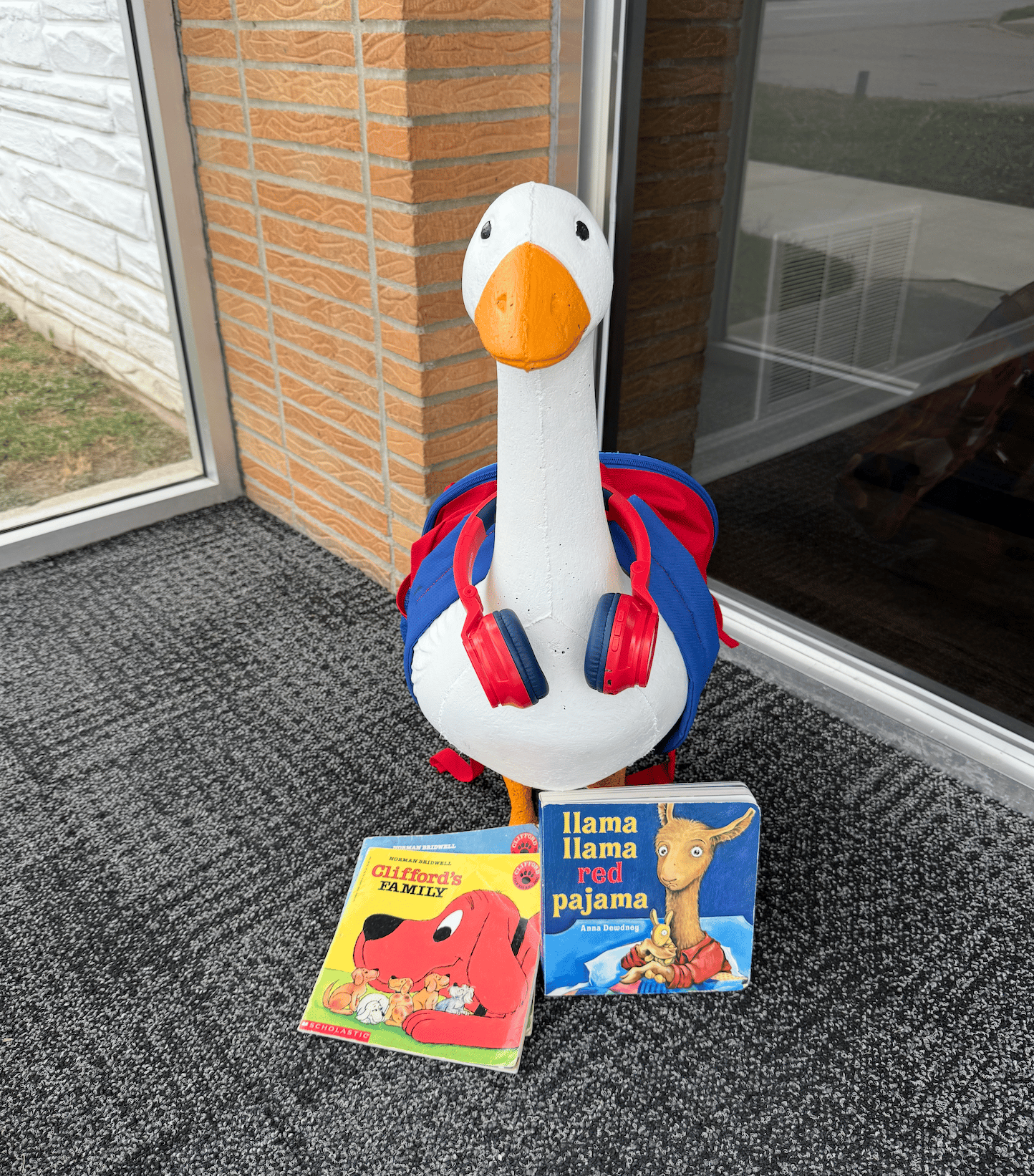 Dressed-up goose with headphones and books in the window of Innovators Insurance