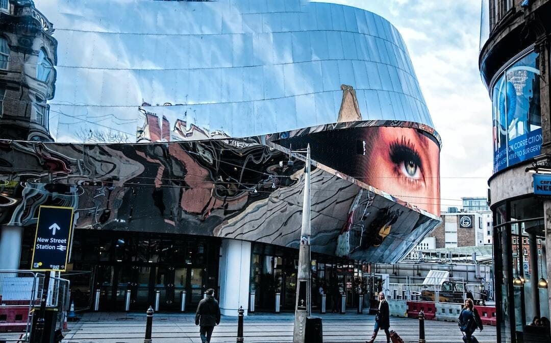 people walking near glass building during daytime