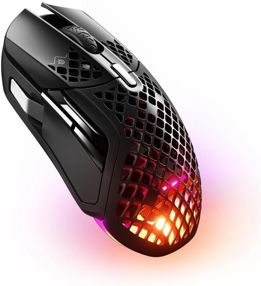 SteelSeries Aerox 5 Wireless – The Mid-Range Marvel A midweight wireless gaming mouse with a honeycomb shell and RGB accents, shown beside a fast-action Rainbow Six Siege gaming session.