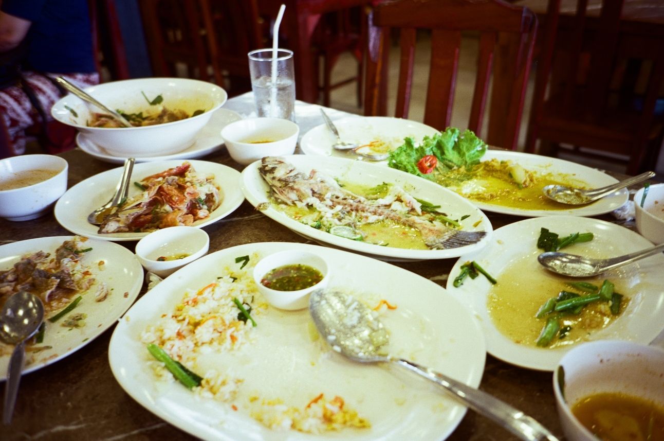 Empty plates on a table with the remains of a seafood feast. Only fishbones are left.