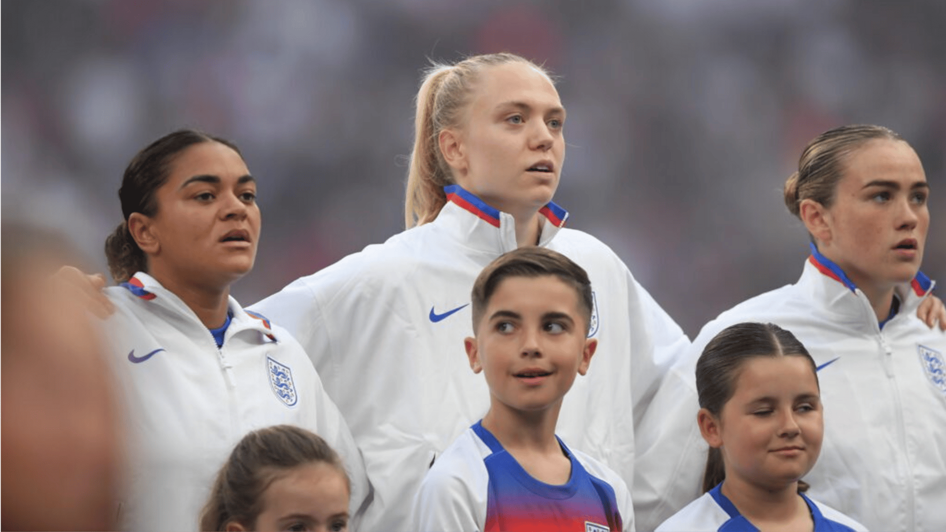 2025 Euros players Jess Carter, Esme Morgan and Grace Clinton of England sing their national anthem prior to the UEFA Women's Nations League 2024/25 Grp A3 MD5 match.