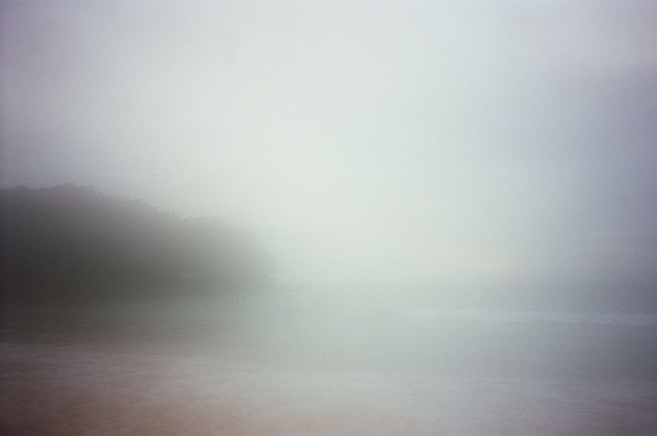 Fog and rain blured view of the beach and ocean.