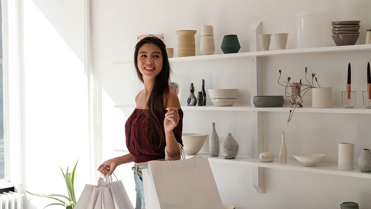 woman with white crisp shopping carrier bags