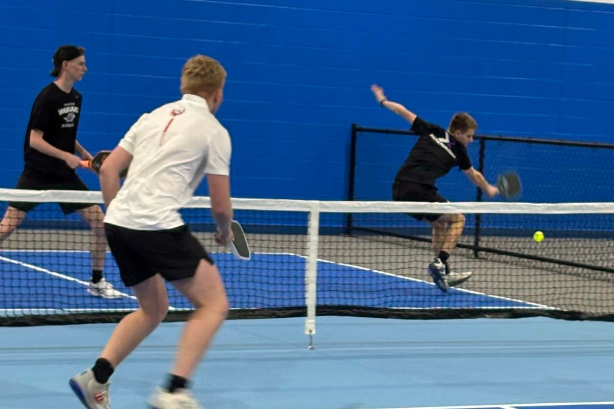 a man returns a pickleball shot