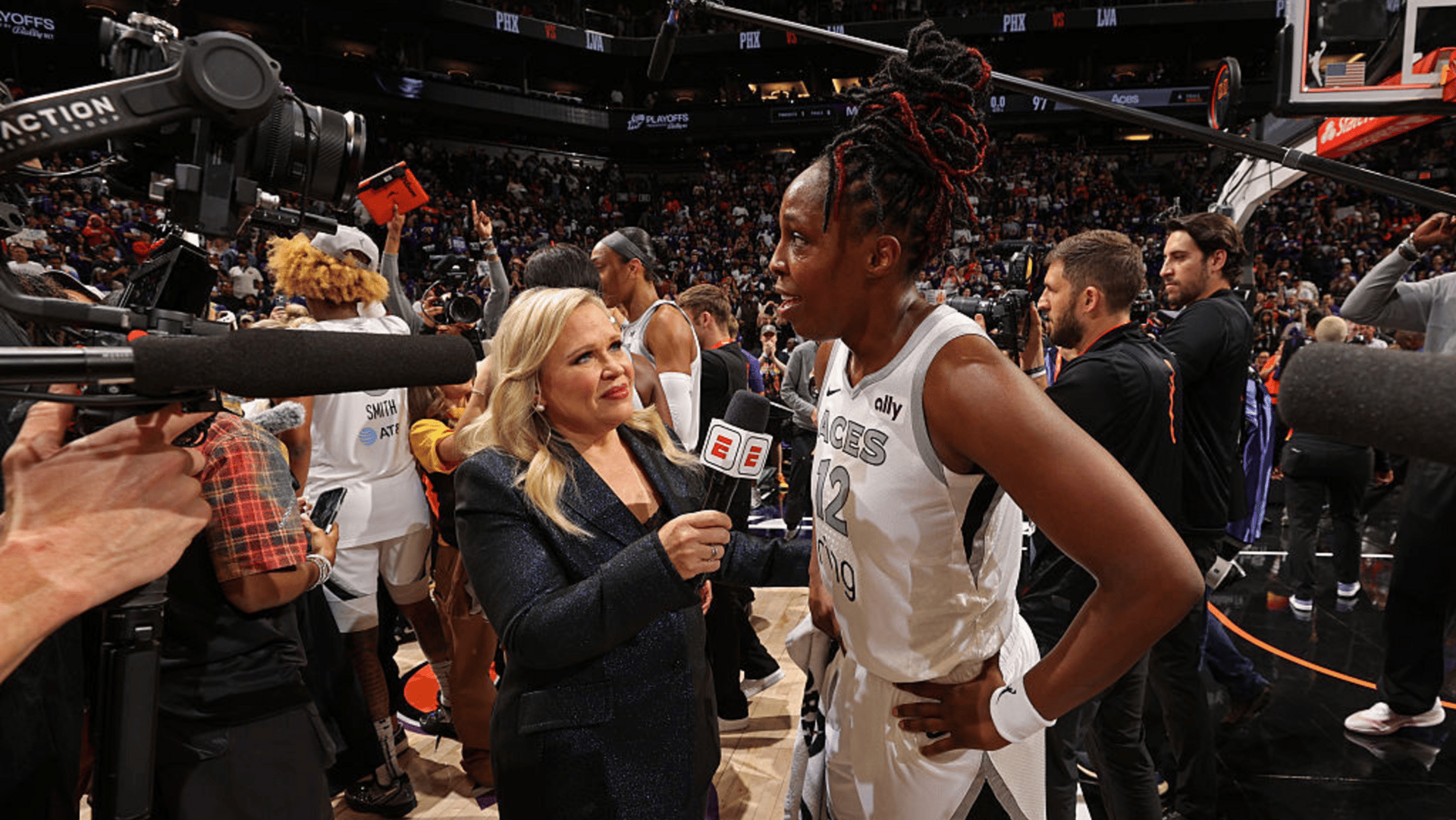 Chelsea Gray #12 of the Las Vegas Aces talks with Holly Rowe from ESPN after the game against the Phoenix Mercury during Game Four of the WNBA Finals on October 10, 2025 at Mortgage Matchup Center in Phoenix, Arizona. 
