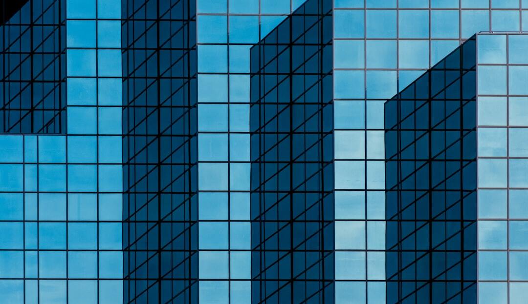 Skyscraper tower with blue glass walls.
