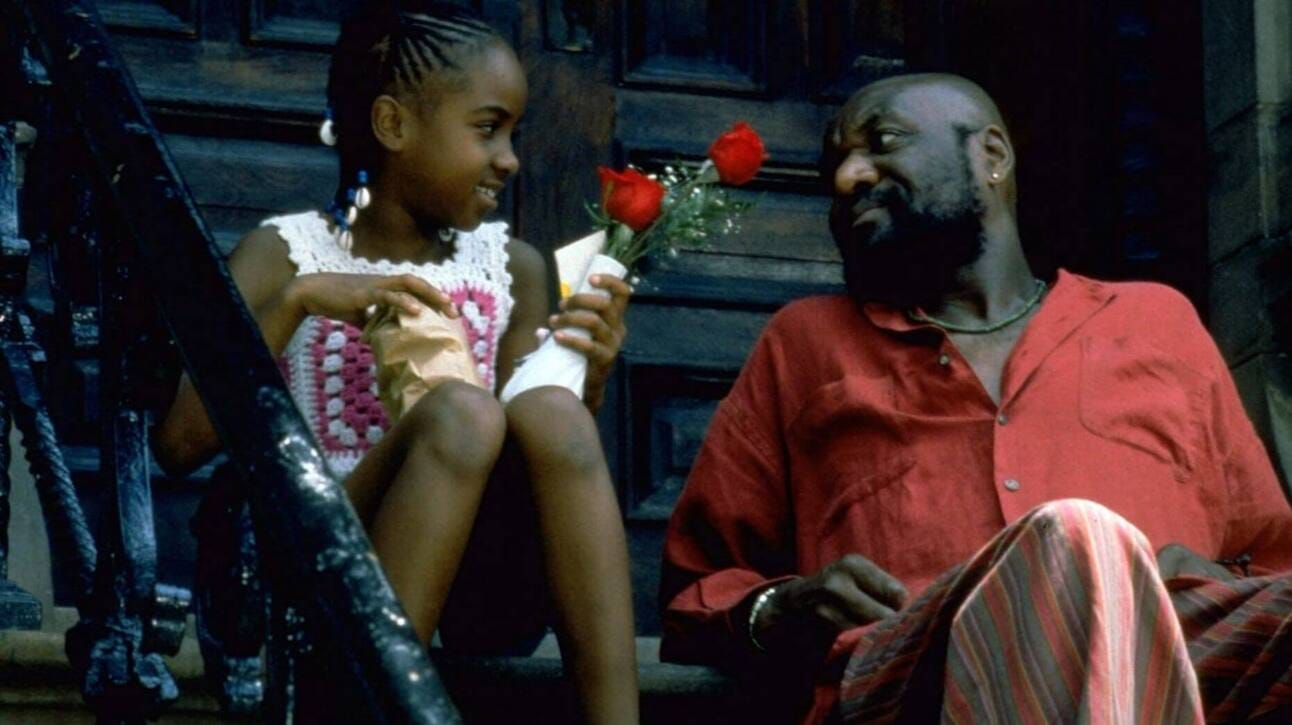 Delroy Lindo as Woody, a father, smiles warmly in a family scene from Crooklyn, a Spike Lee film celebrating Black life in 1970s Brooklyn.